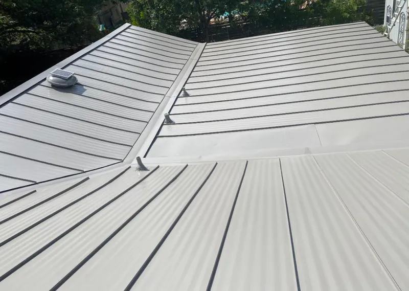 Solar attic fan installed on a metal roof for Roof Ventilation in Maquoketa